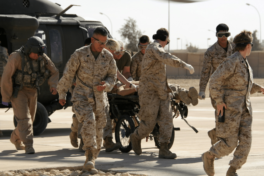 Marines and sailors rush a patient from a helicopter into the Shock Trauma Platoon area. The scene described in the story may have looked something like this. USMC photo by Cpl. James B. Hoke.