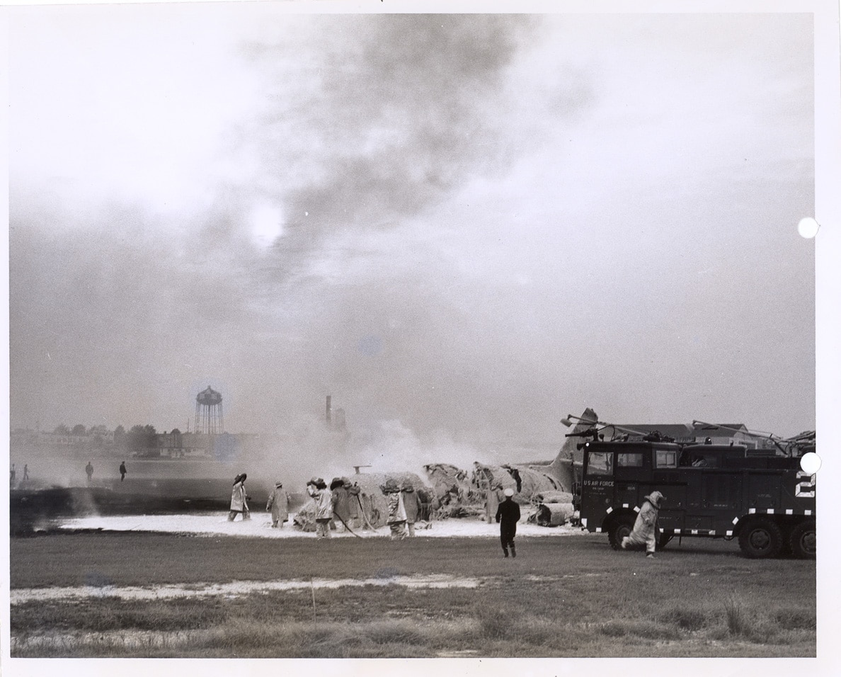Firefighters extinguish the JetStar that crashed while landing at Robins AFB in 1962.
